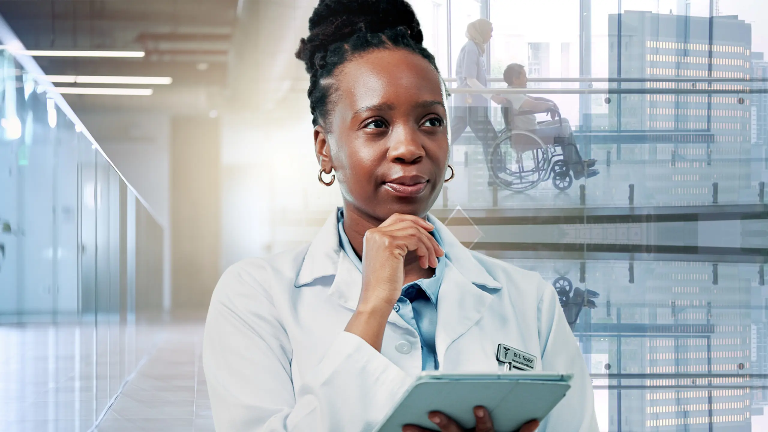 Physician in a white coat holding a tablet and considering a pre-bill CDI review, with a patient in a wheelchair behind